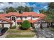 Front view of a two story townhome with attached garage and Spanish tile roof at 3400 Gray Fox Cv, Apopka, FL 32703