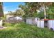 Backyard with overgrown grass and sheds at 447-441 N Lincoln St, Daytona Beach, FL 32114