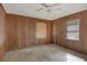 Small bedroom with wood paneling and ceiling fan at 447-441 N Lincoln St, Daytona Beach, FL 32114