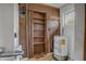 Small laundry room with shelving, water heater, and AC unit at 447-441 N Lincoln St, Daytona Beach, FL 32114