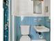 Small bathroom with blue tile, toilet, and sink at 447-441 N Lincoln St, Daytona Beach, FL 32114