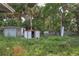 Overgrown backyard with storage sheds at 447-441 N Lincoln St, Daytona Beach, FL 32114