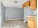 Small kitchen with wood cabinets and gray walls at 447-441 N Lincoln St, Daytona Beach, FL 32114