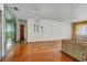 Living room with hardwood floors, brick wall, and chandelier at 447-441 N Lincoln St, Daytona Beach, FL 32114