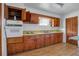 Retro kitchen features wood cabinets, laminate flooring, and vintage appliances at 447-441 N Lincoln St, Daytona Beach, FL 32114