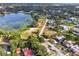 Wide aerial view of lakefront property and neighborhood at 504 Osceola Ave, Eustis, FL 32726