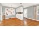 Hardwood floors, built-in white shelving, and a charming chandelier at 504 Osceola Ave, Eustis, FL 32726