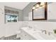 Elegant bathroom with dual sinks, updated fixtures and subway tile at 504 Osceola Ave, Eustis, FL 32726