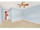 Spacious bedroom with light blue walls and carpeted floors at 504 Osceola Ave, Eustis, FL 32726