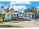 Light gray single-story house with a landscaped yard and driveway at 504 Osceola Ave, Eustis, FL 32726