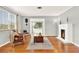 Living room with hardwood floors, fireplace, and wicker armchairs at 504 Osceola Ave, Eustis, FL 32726