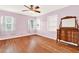 Charming bedroom with hardwood floors and built-in shelving at 504 Osceola Ave, Eustis, FL 32726