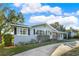 Light gray single-story house with black shutters, landscaped yard, and driveway at 504 Osceola Ave, Eustis, FL 32726