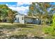 Exterior view of a charming light gray house at 504 Osceola Ave, Eustis, FL 32726