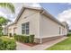 Tan house with a one-car garage and lush landscaping at 3825 Quaint Ln # F, Clermont, FL 34711