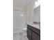 Clean bathroom with white tiled walls, a bathtub, and dark vanity at 3825 Quaint Ln # F, Clermont, FL 34711