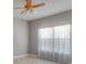 Spacious bedroom with light grey walls, ceiling fan, and neutral curtains at 3825 Quaint Ln # F, Clermont, FL 34711