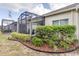 Landscaped backyard with a screened patio at 3825 Quaint Ln # F, Clermont, FL 34711