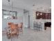 Bright dining area with a charming vintage table and chairs, adjacent to a modern kitchen at 3825 Quaint Ln # F, Clermont, FL 34711