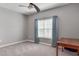 Bedroom with grey walls, ceiling fan, and neutral curtains at 3825 Quaint Ln # F, Clermont, FL 34711
