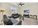 Relaxing living room featuring two black sofas, a coffee table, and a large TV at 650 Pebble Beach Dr, Davenport, FL 33896