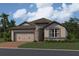New home exterior with neutral tones and landscaping at 5286 Teirgarten St, St Cloud, FL 34771