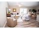 Bright and airy living room with comfortable seating and hardwood floors at 107 Oceans Cir, Daytona Beach Shores, FL 32118