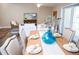 Dining area with wooden table, blue vase, and access to balcony at 107 Oceans Cir, Daytona Beach Shores, FL 32118