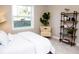 Bedroom with a blue headboard, white bedding, and a bookshelf at 107 Oceans Cir, Daytona Beach Shores, FL 32118