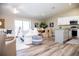 Open-concept living room and kitchen with white cabinets and a kitchen island at 107 Oceans Cir, Daytona Beach Shores, FL 32118