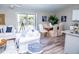 Open living and dining area with hardwood floors and sliding glass doors at 107 Oceans Cir, Daytona Beach Shores, FL 32118