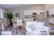 Living room with white slipcovered sofas and view into dining area at 107 Oceans Cir, Daytona Beach Shores, FL 32118