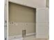 Laundry room with a white door and built-in storage at 107 Oceans Cir, Daytona Beach Shores, FL 32118