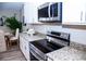 Modern kitchen features stainless steel appliances and granite countertops at 107 Oceans Cir, Daytona Beach Shores, FL 32118