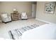 Spacious bedroom with two armchairs and neutral decor at 107 Oceans Cir, Daytona Beach Shores, FL 32118