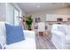 Living room with white sofas and blue striped pillows at 107 Oceans Cir, Daytona Beach Shores, FL 32118
