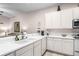 Well-equipped kitchen with white cabinets and double sink at 101 New Providence # 9101, Davenport, FL 33897