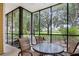 Screened porch with a table and chairs, offering a view of the backyard at 101 New Providence # 9101, Davenport, FL 33897