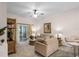 Bright living room with comfy seating, glass coffee table, and sliding glass doors leading to a screened patio at 101 New Providence # 9101, Davenport, FL 33897