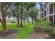 Landscaped lawn area with mature trees behind the building at 101 New Providence # 9101, Davenport, FL 33897