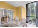 Screened patio with glass-top table and chairs; view of interior dining area at 101 New Providence # 9101, Davenport, FL 33897