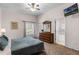 Spacious main bedroom with a king-size bed, dresser, and en-suite bathroom at 101 New Providence # 9101, Davenport, FL 33897