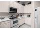 White kitchen with stainless steel appliances and ample counter space at 101 New Providence # 9101, Davenport, FL 33897