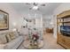 Open living room with a view of kitchen, dining area and neutral colored couch at 101 New Providence # 9101, Davenport, FL 33897