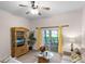 Living room features a ceiling fan, wicker media cabinet, and access to a screened patio at 101 New Providence # 9101, Davenport, FL 33897
