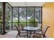 Private screened patio with outdoor seating and lush greenery views at 101 New Providence # 9101, Davenport, FL 33897