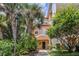 Two-story building with peach-colored siding, lush landscaping, and walkway at 101 New Providence # 9101, Davenport, FL 33897