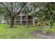 Building with balconies and screened porches, nestled among trees at 101 New Providence # 9101, Davenport, FL 33897