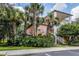 Building exterior showcasing peach-colored siding, palm trees, and landscaping at 101 New Providence # 9101, Davenport, FL 33897