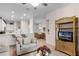 Open living area with kitchen, dining area, and wicker media cabinet at 101 New Providence # 9101, Davenport, FL 33897
